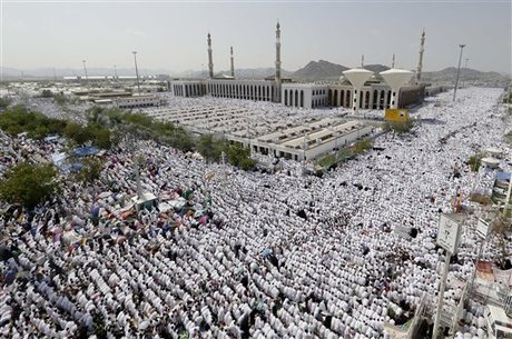 Muslim pilgrim head to pray outside Namira mosque in Arafat near the holy city of Mecca, Saudi Arabia, Thursday, Oct. 25, 2012. Saudi authorities say around 3.4 million pilgrims some 1.7 million of them from abroad have arrived in the holy cities of Mecca and Medina for this year's pilgrimage. (AP Photo/Hassan Ammar)
